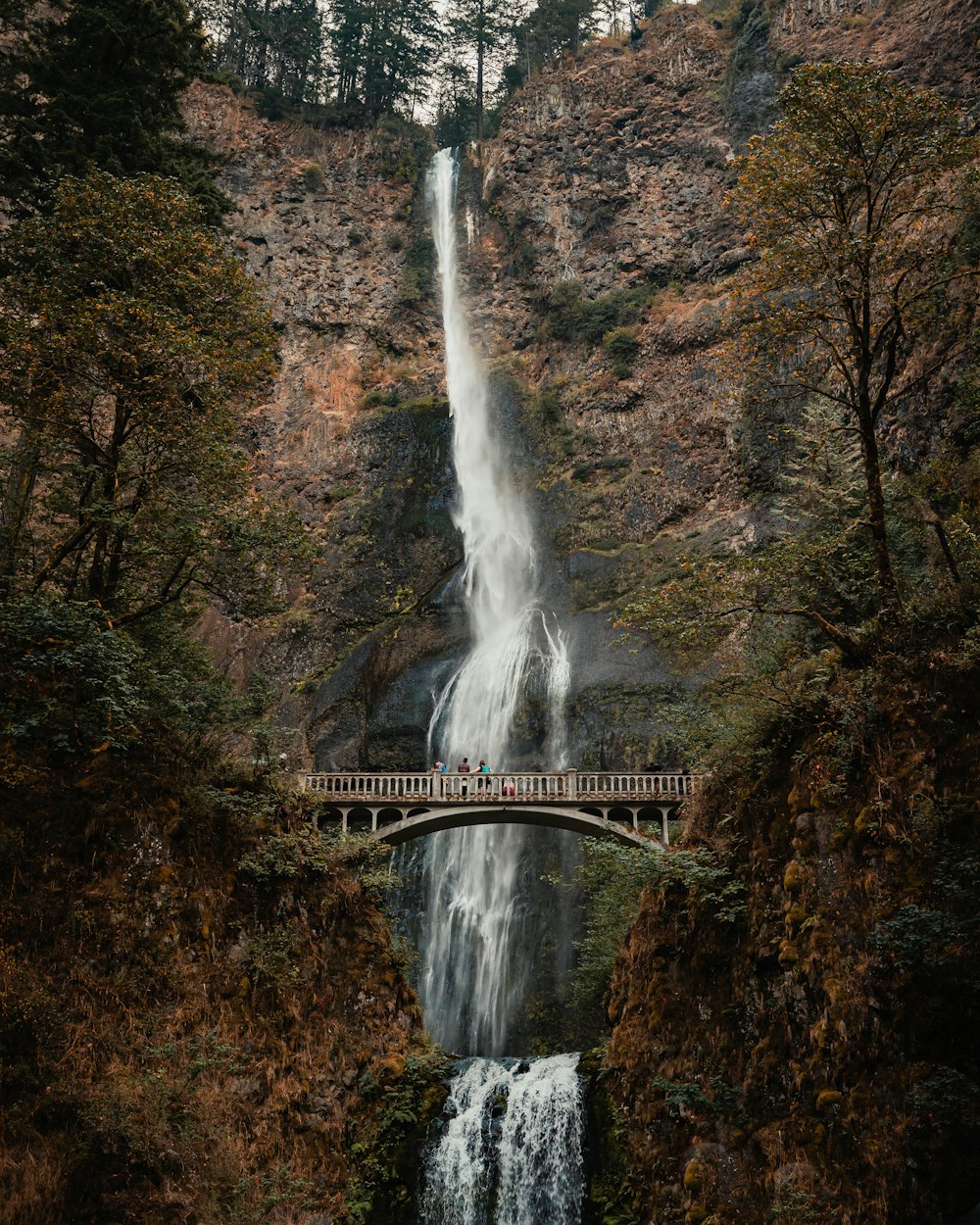 a bridge over a waterfall