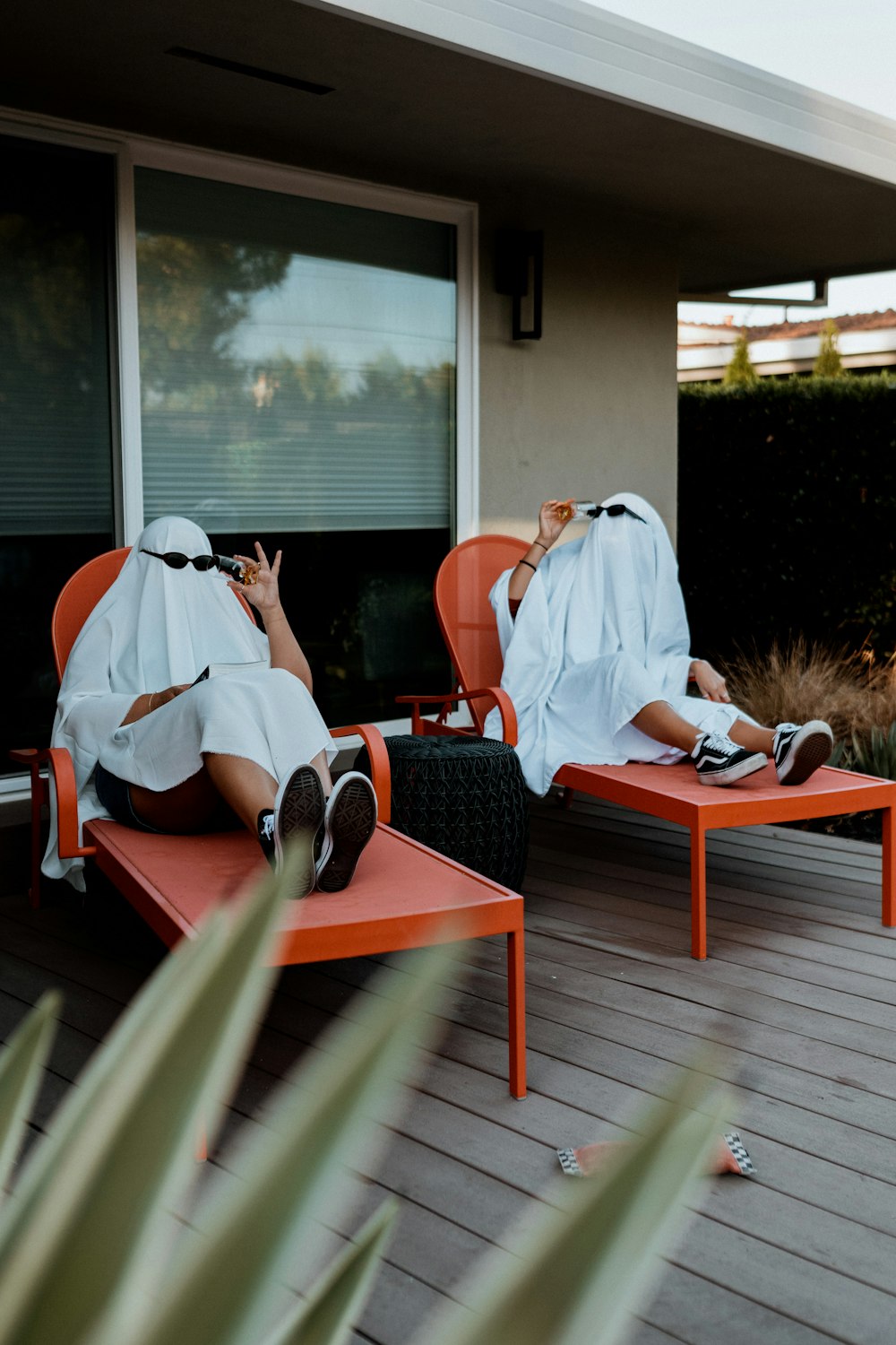 a person taking a picture of another man sitting on a bench