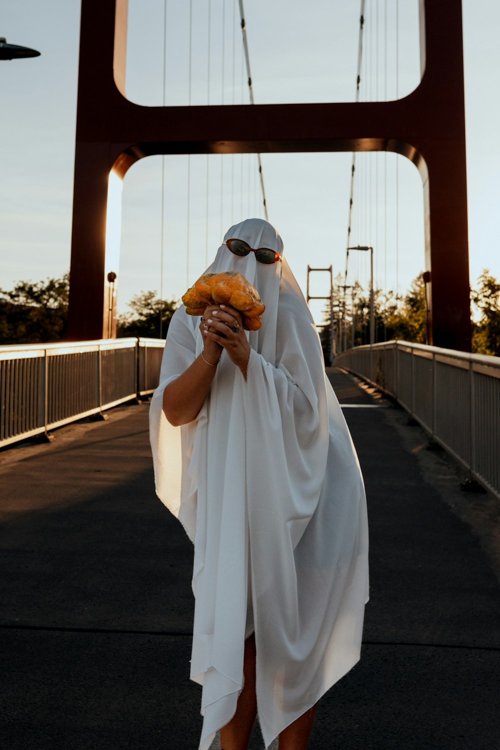 a man wearing a white robe and holding a burger