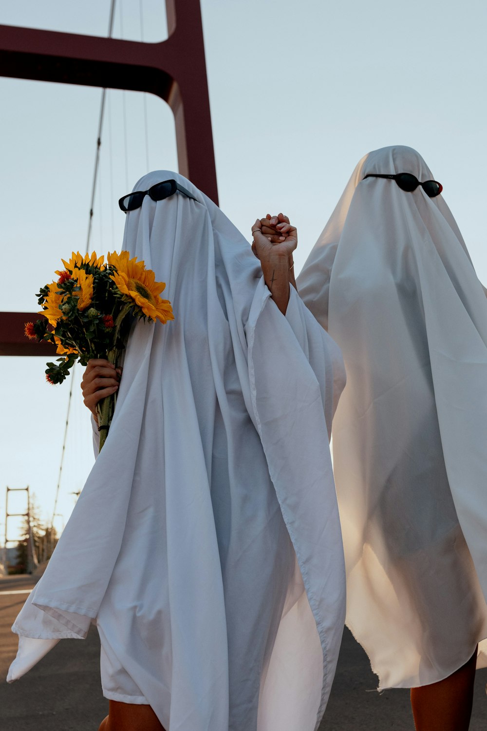 a person wearing a white dress holding flowers