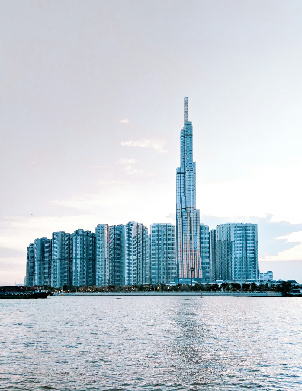 a city skyline with a body of water in the foreground