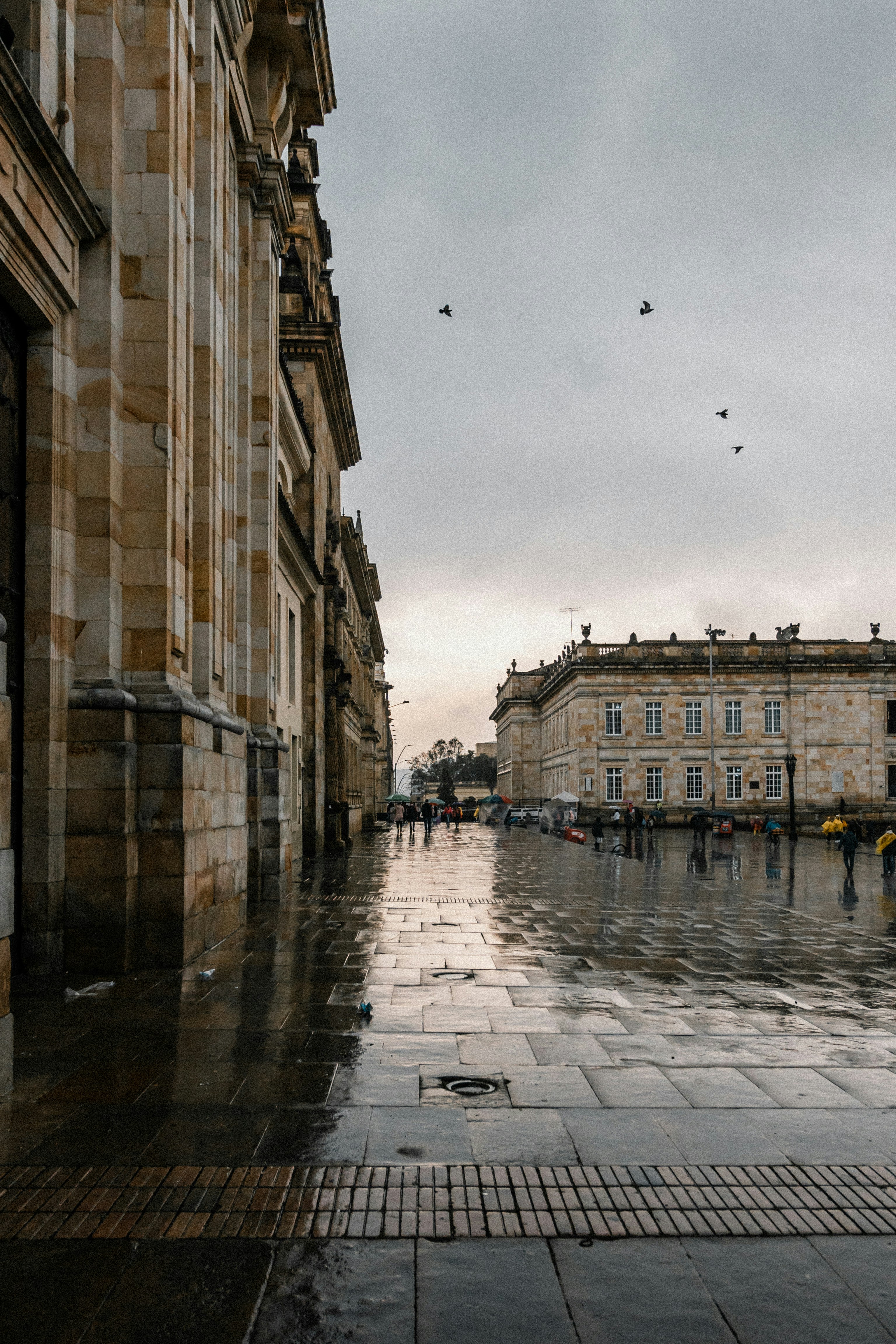 a wet street between buildings