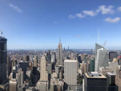 A panoramic view of London’s financial district with iconic buildings under a clear sky.
