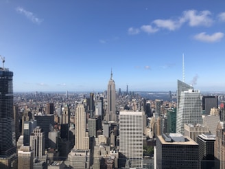 A panoramic cityscape showing diverse skyscrapers and landmarks from multiple continents under a clear sky.