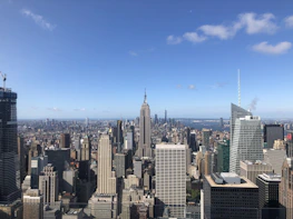 A panoramic view of London’s financial district with iconic buildings under a clear sky.