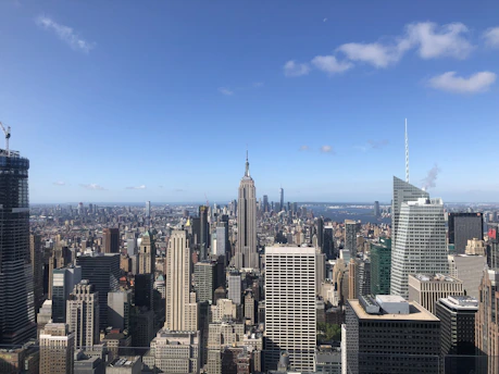 A panoramic view of New York City skyline with skyscrapers and the Hudson River