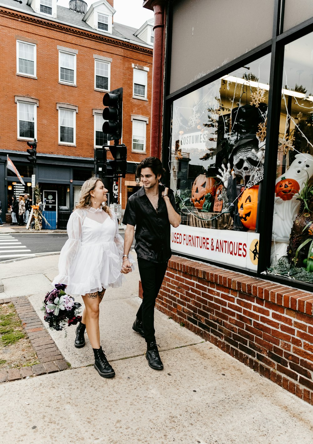 a man and woman walking down a sidewalk