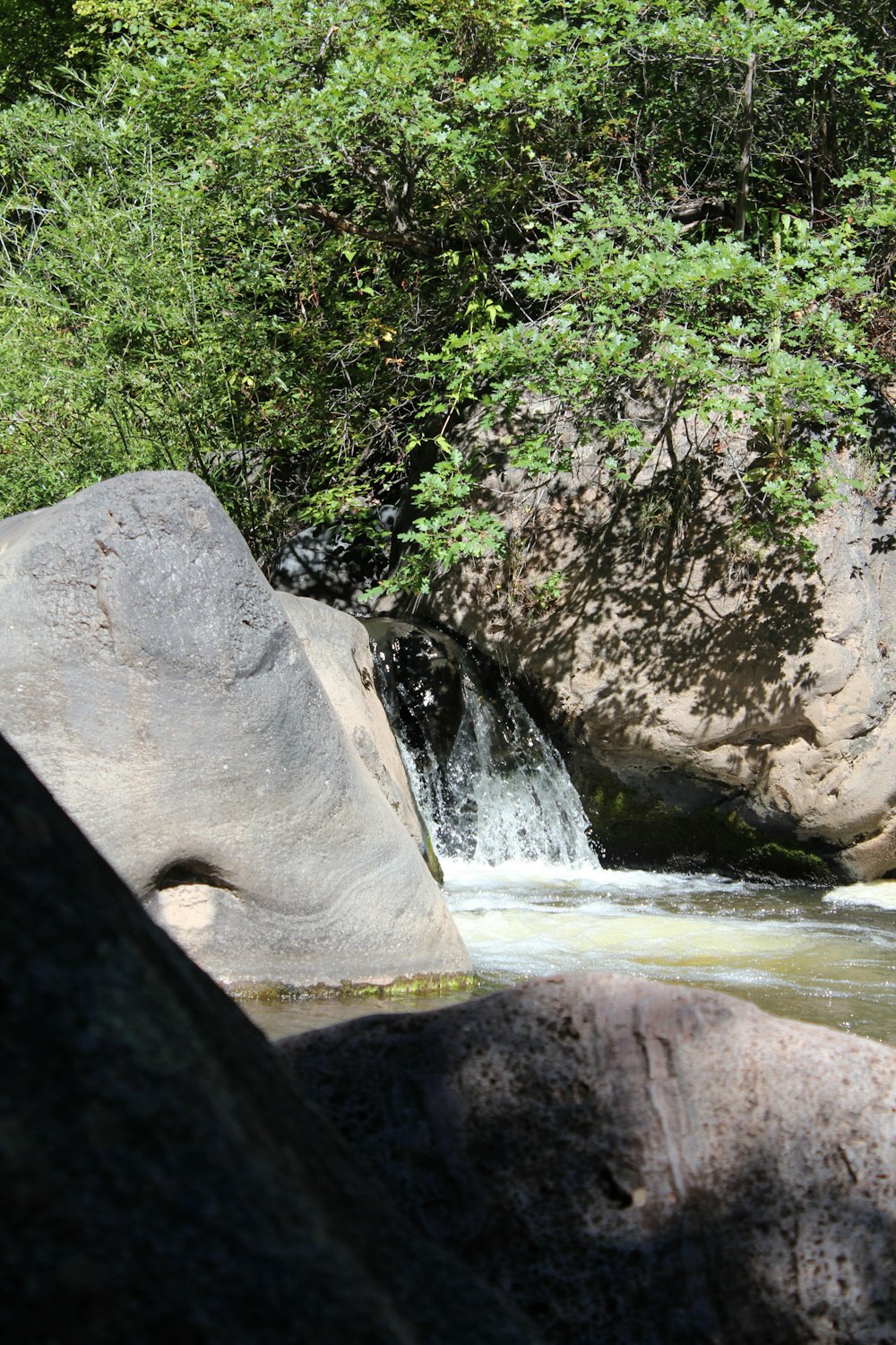 a waterfall over a rock