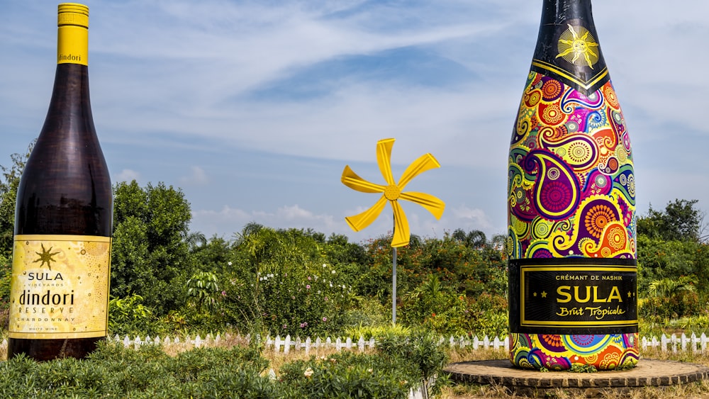 a couple of bottles with a flower in front of them