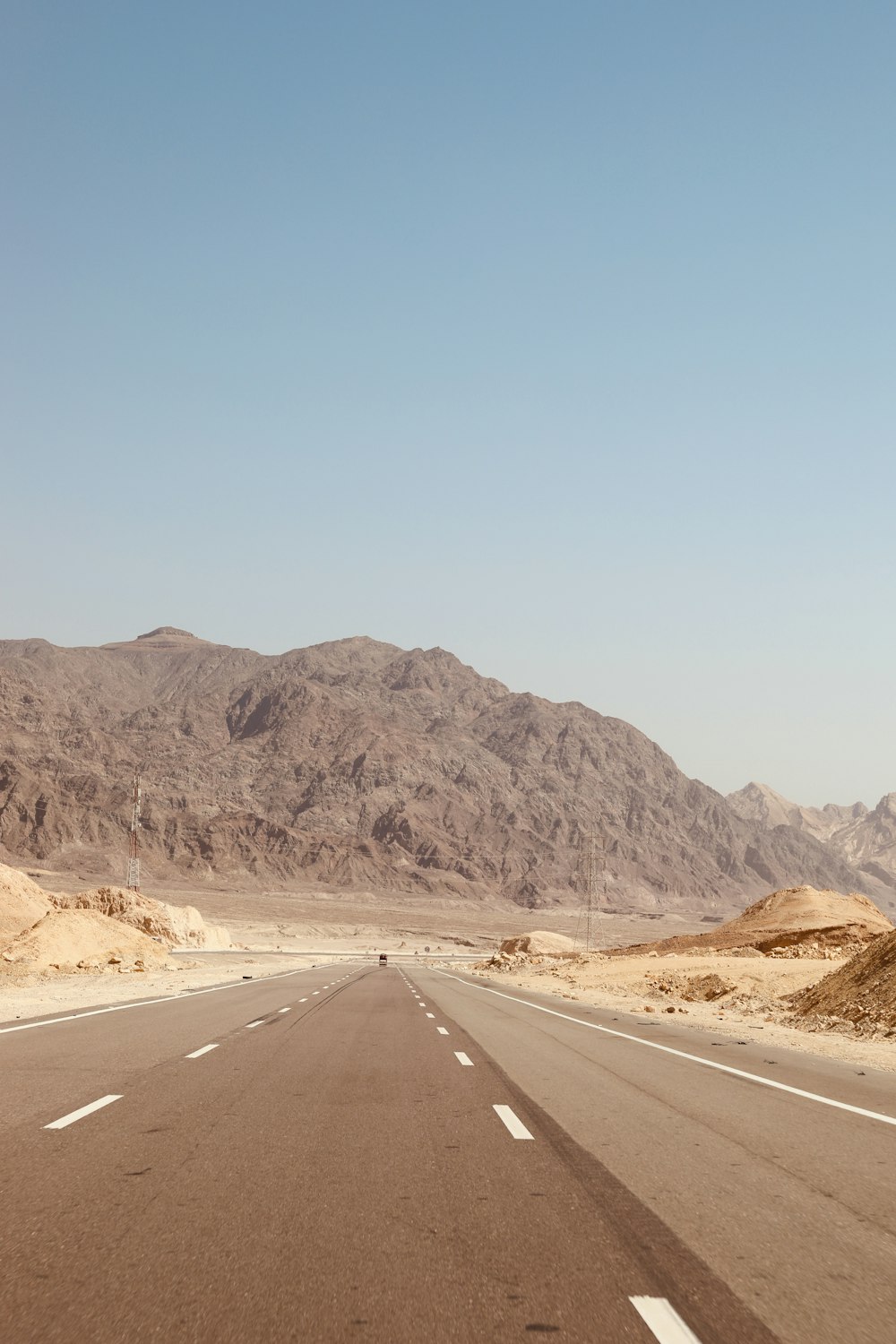 a road with a mountain in the background