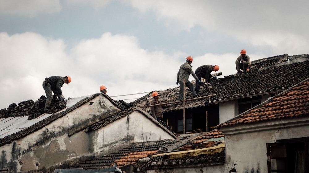 a group of men on top of a roof