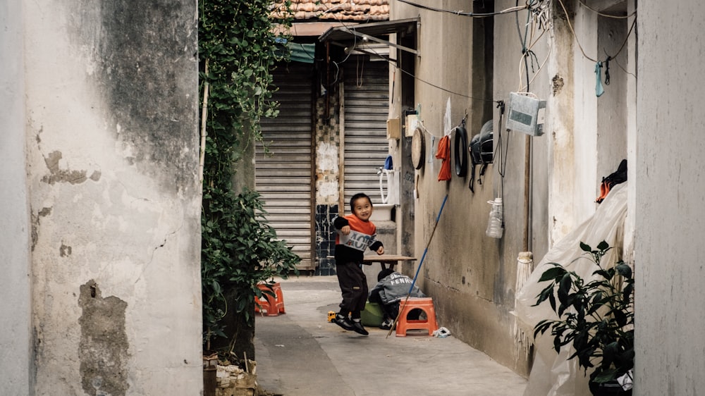 a person with a broom and a bucket outside a house