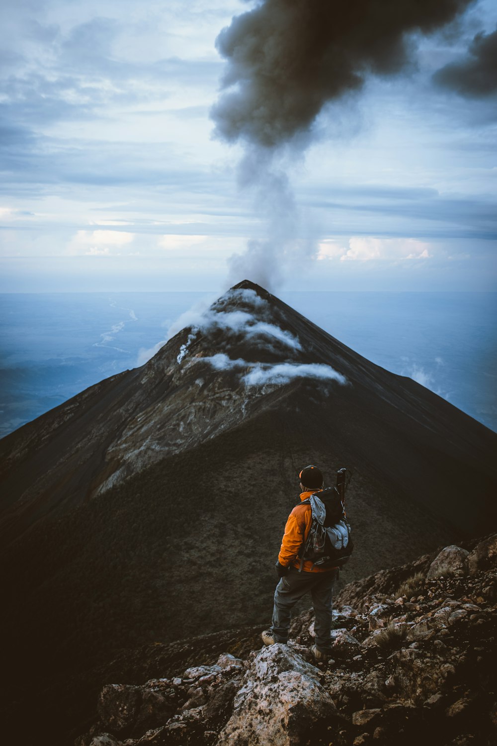 a man standing on a rocky cliff