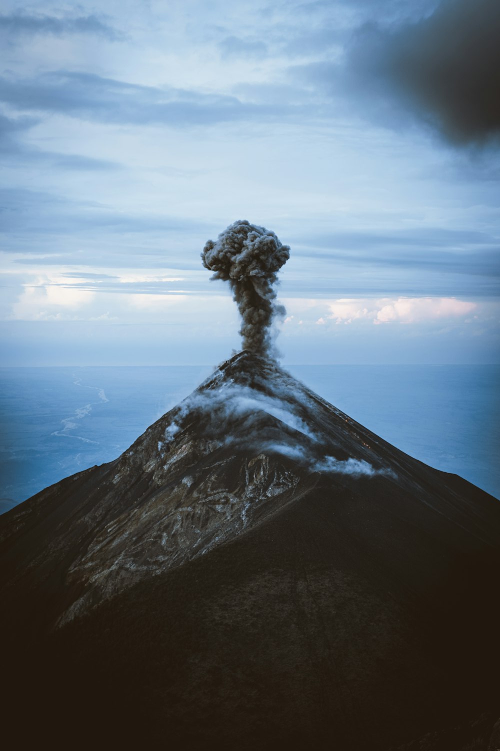 a mountain with a cloud of smoke