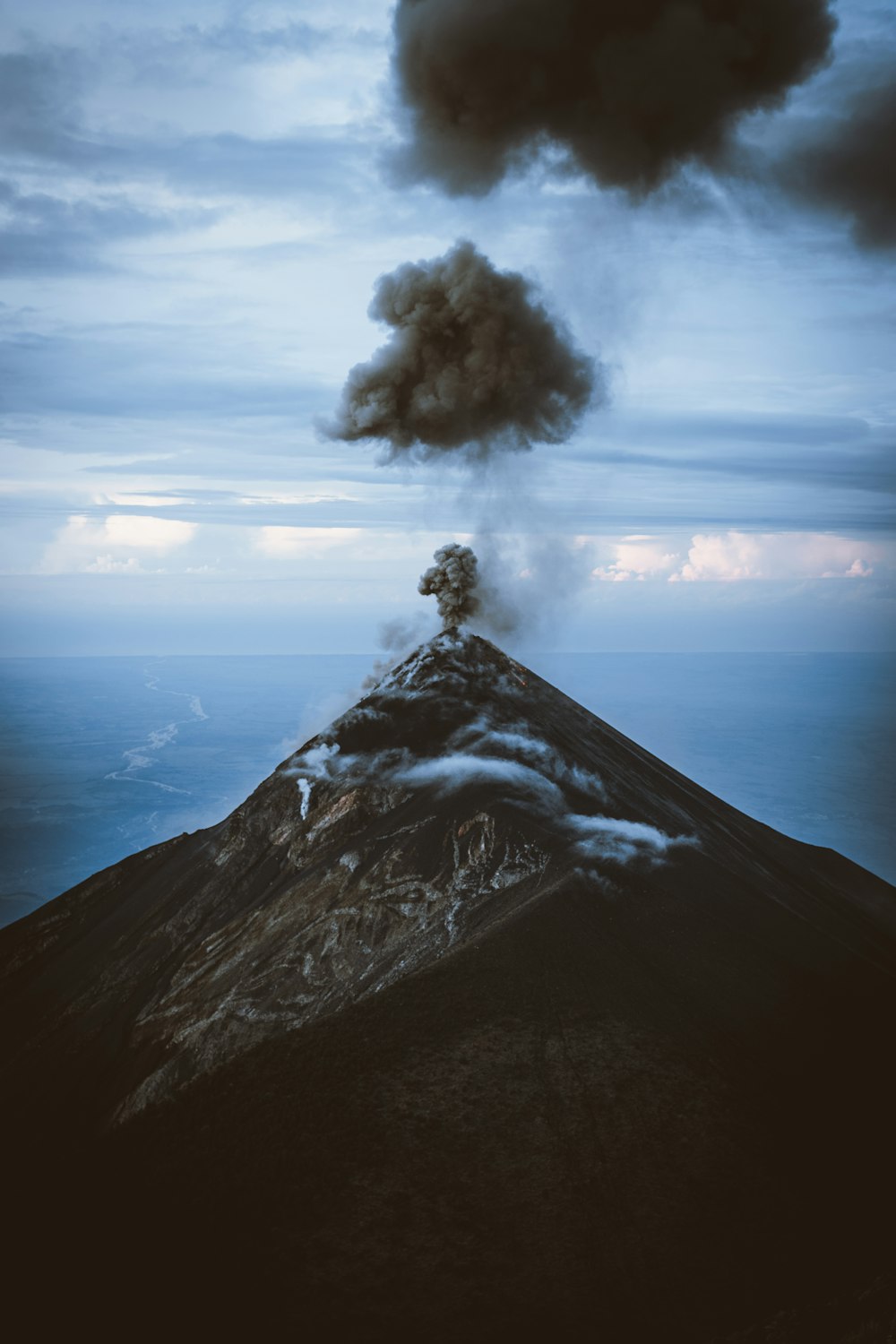 a volcano erupting with smoke