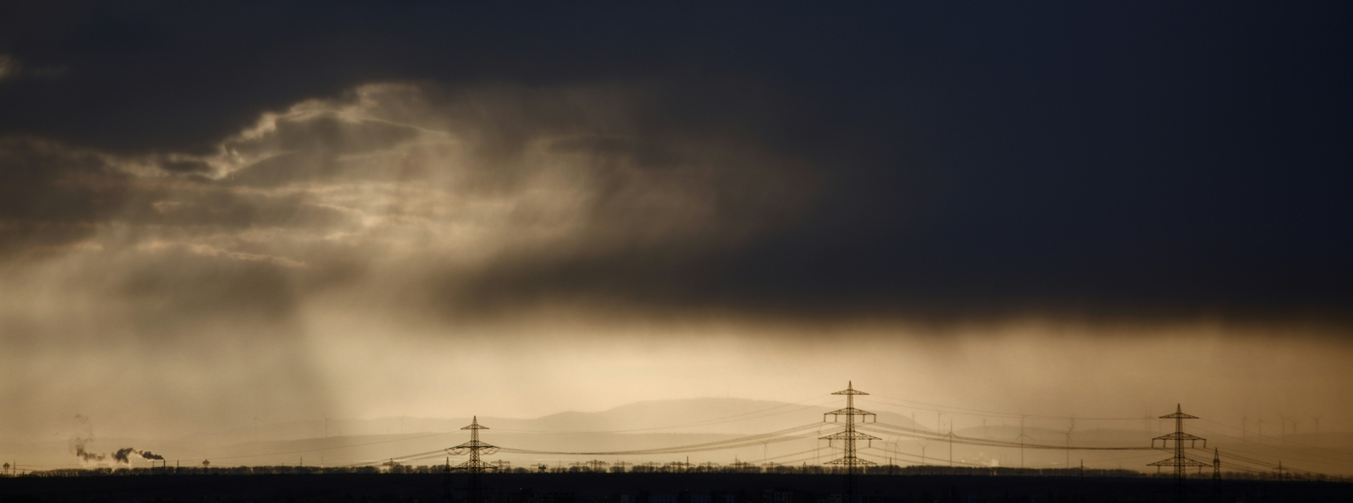 a cloudy sky over power lines