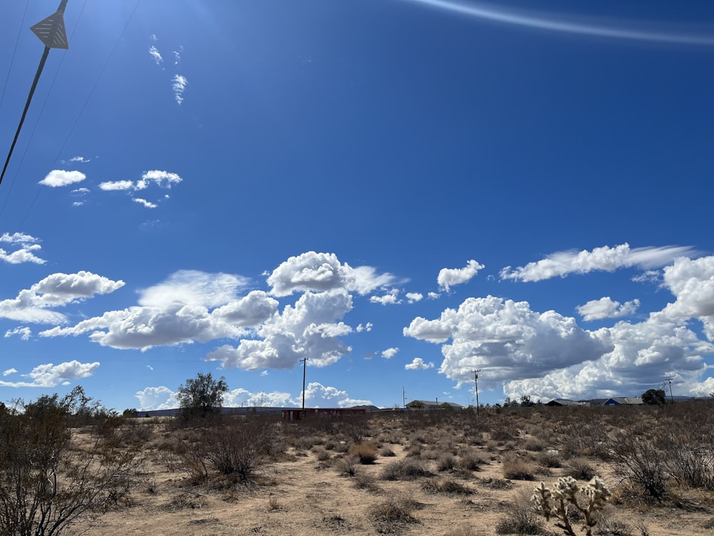 a landscape with a blue sky and clouds