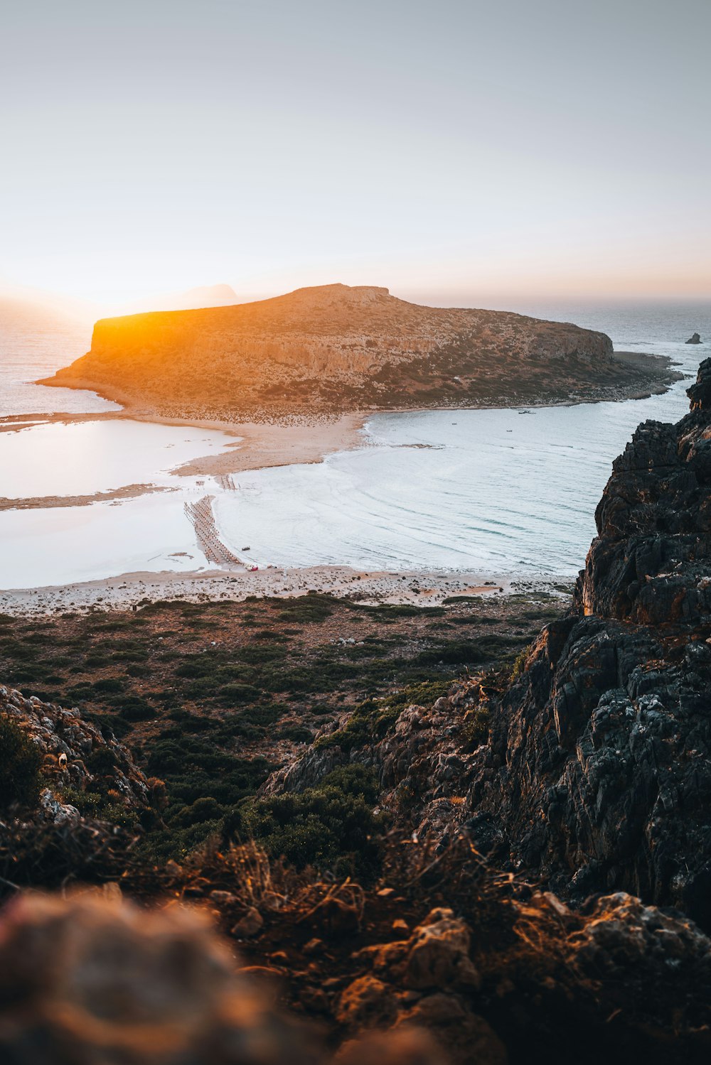 a beach with a hill in the background