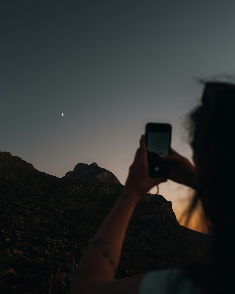 a man taking a picture of a mountain