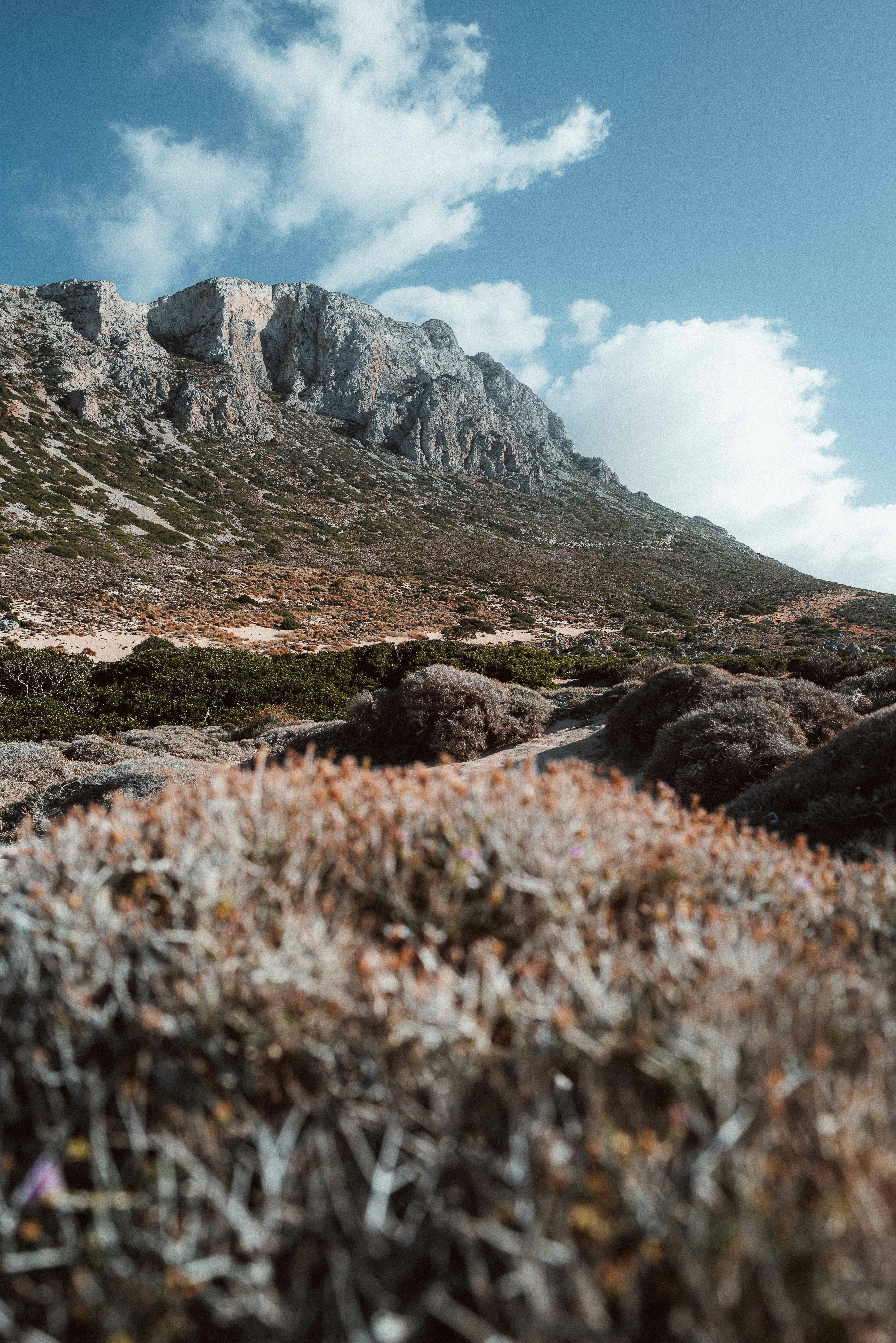 a rocky mountain with a blue sky