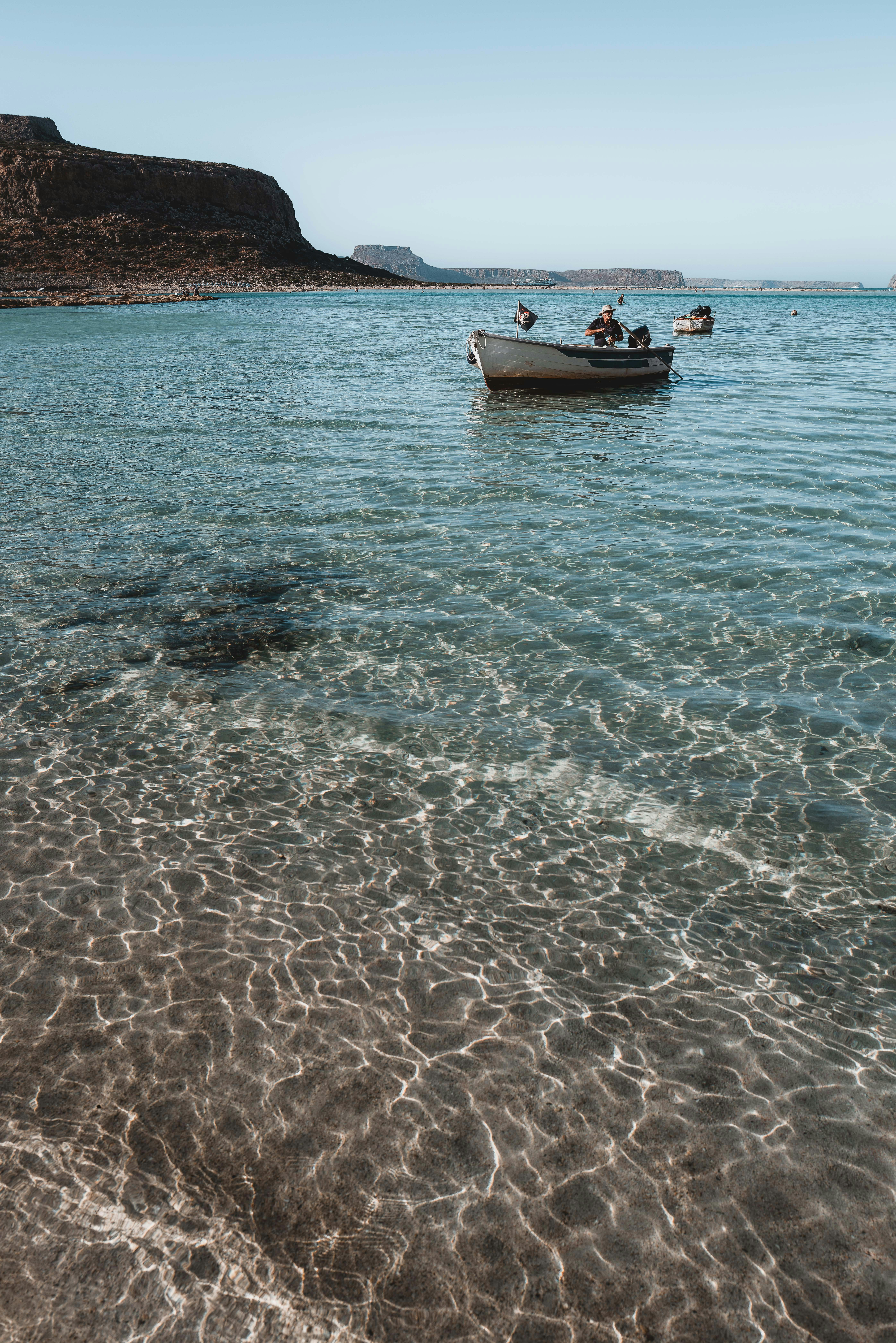a group of people in a boat on a beach