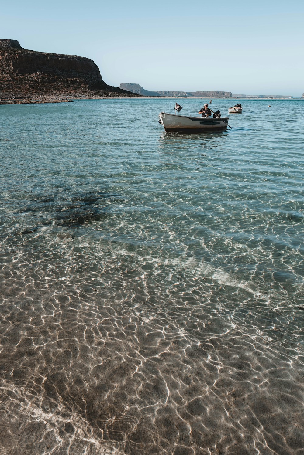 a group of people in a boat on a beach