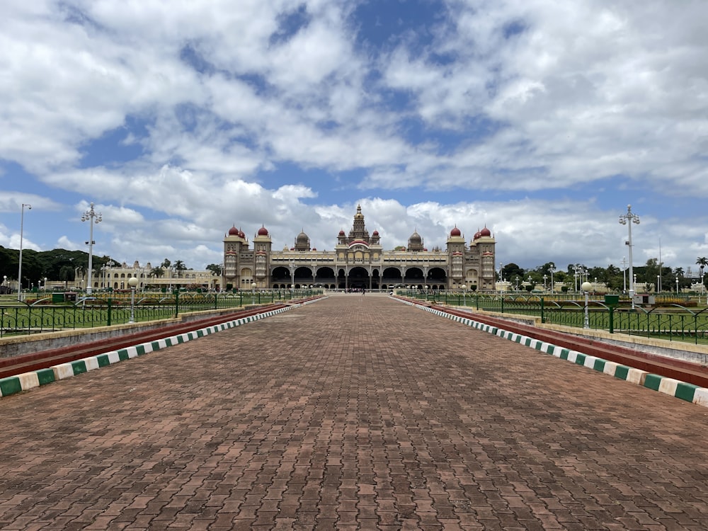 a brick walkway leading to a large building