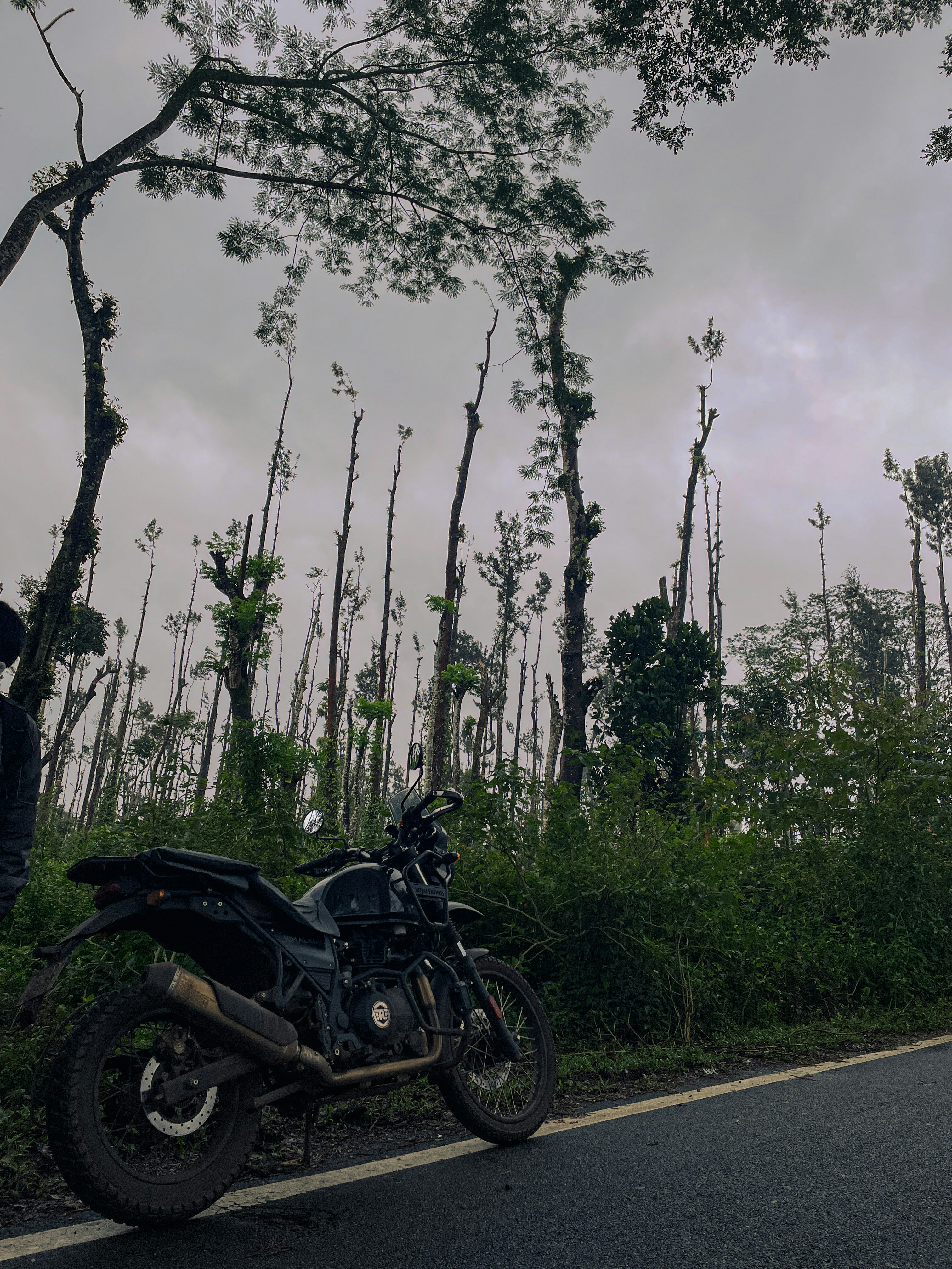 A motorcycle parked on the side of a road photo – Free Chikmagalur ...