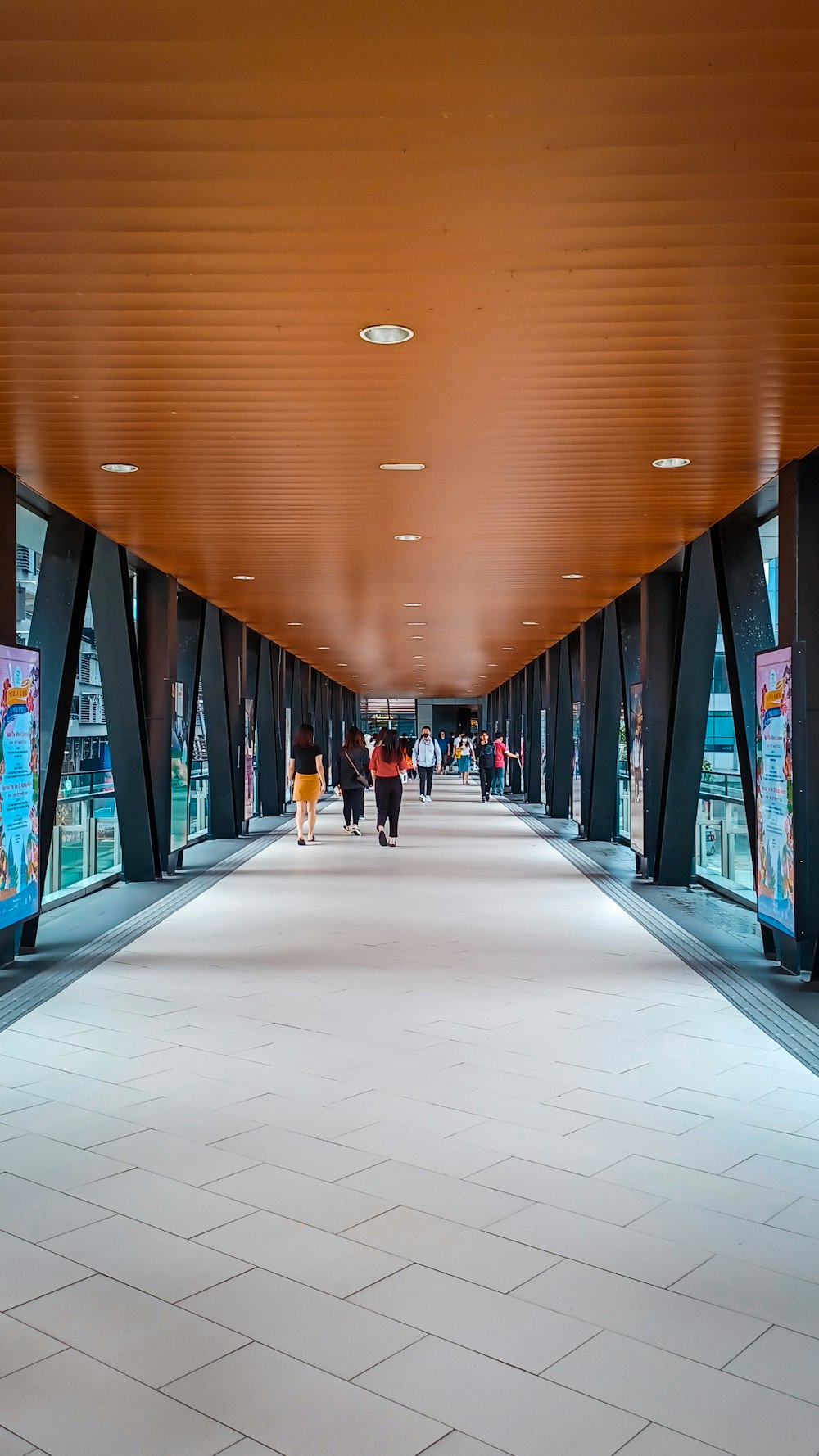 people walking in a large room with many computer screens