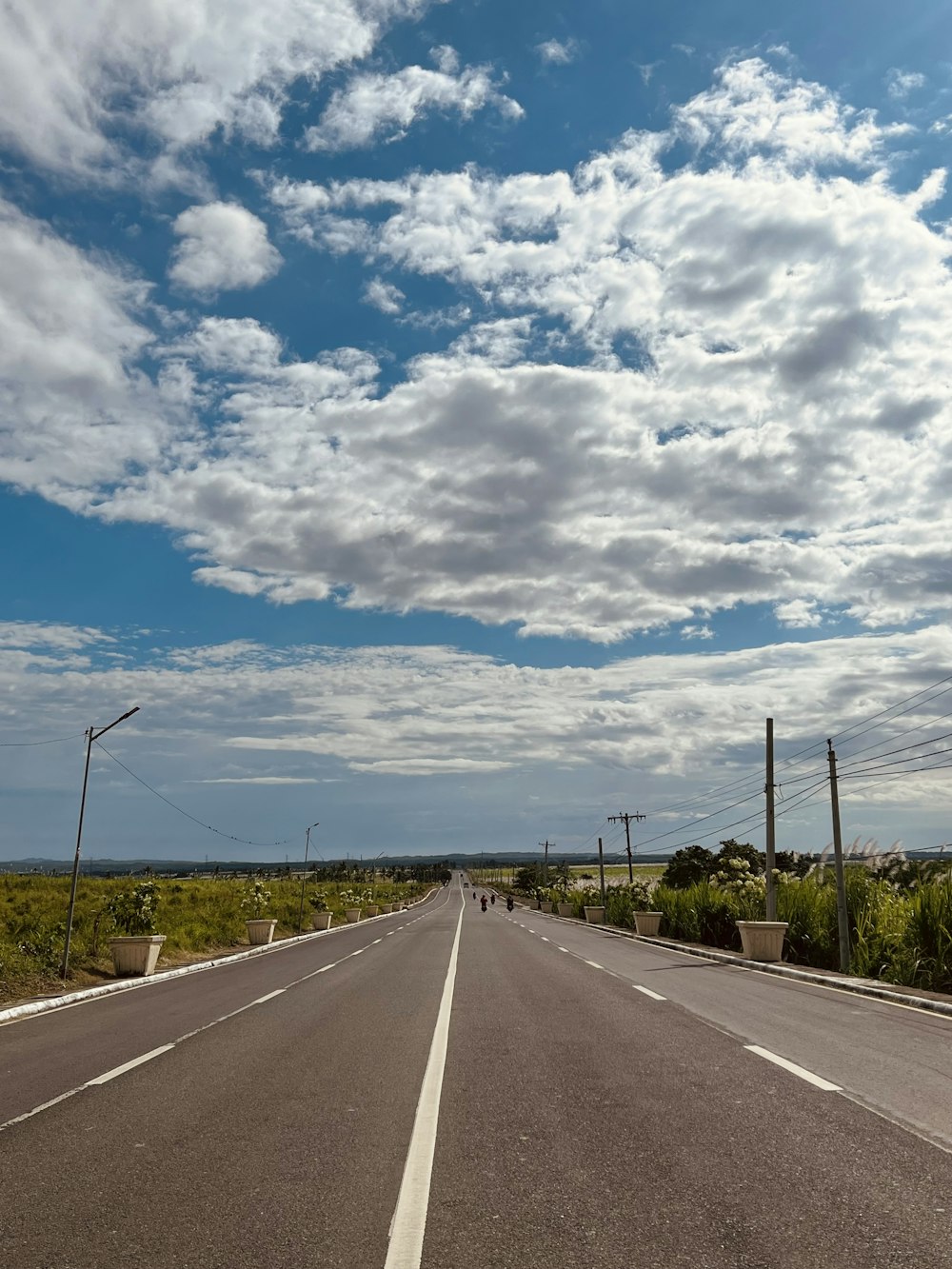 a road with clouds above