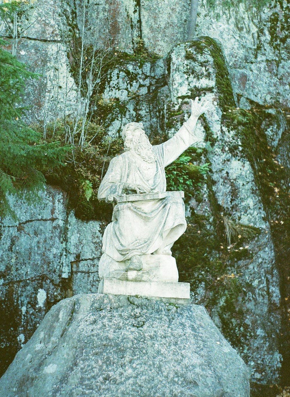 a statue of a person holding a book