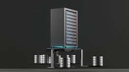 A digital rendering depicting a tall, metallic server rack positioned centrally on a platform. The server appears to have multiple blue-lit slots. Surrounding the rack, there are several stacks of cylindrical objects resembling databases or storage units, all set against a dark background.