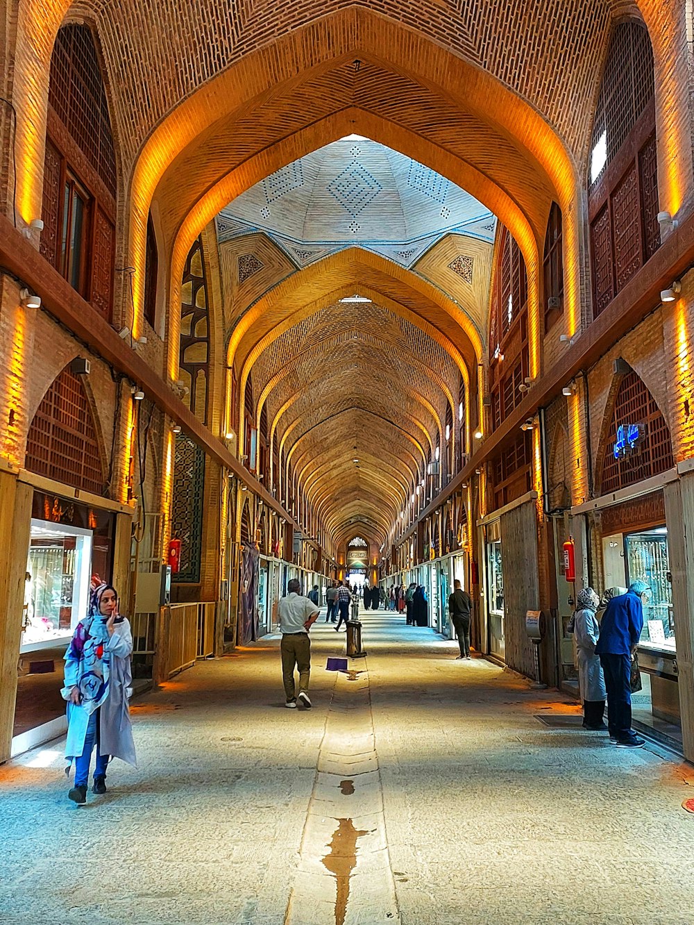 a group of people walking through a building