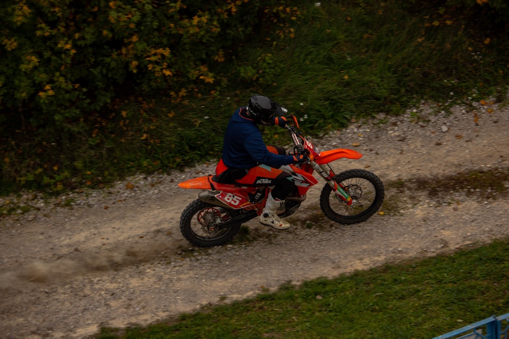 a person riding a motorcycle on a dirt road