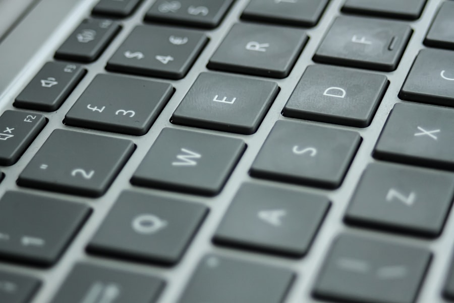 Hands typing on a laptop keyboard composing an email