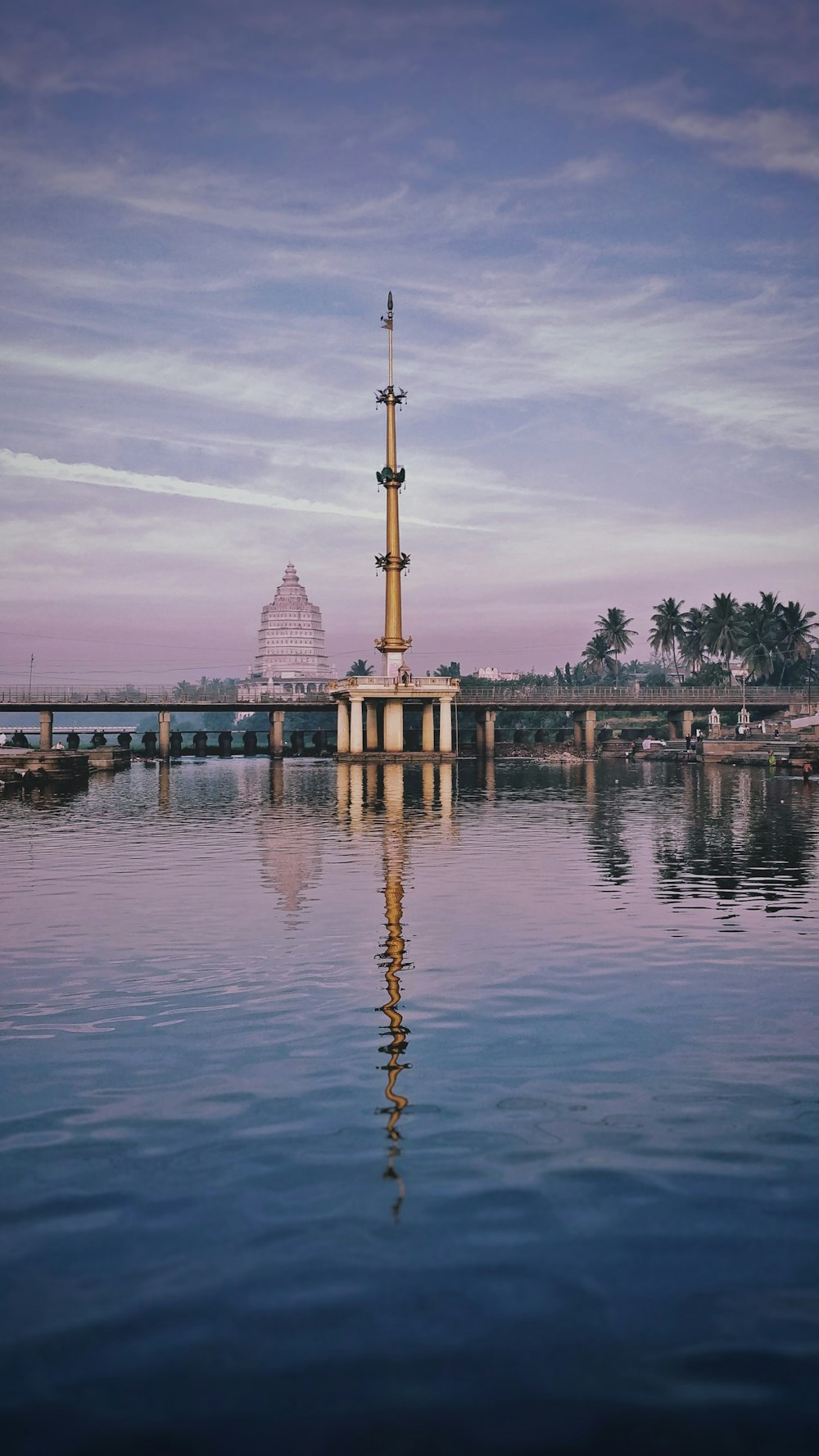 a body of water with a tower in the background