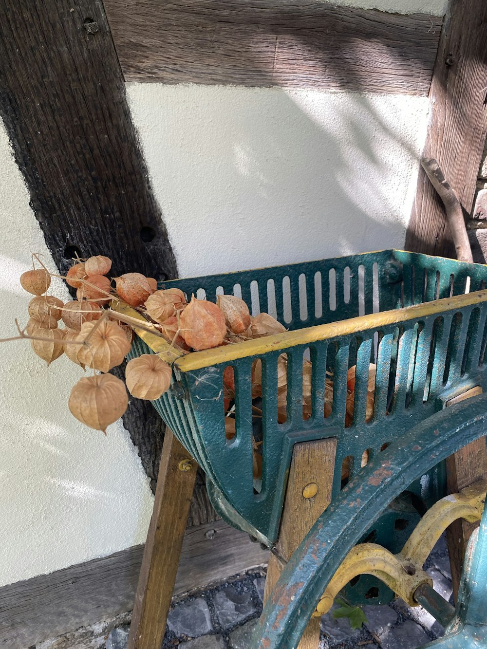 a wooden bench with leaves on it