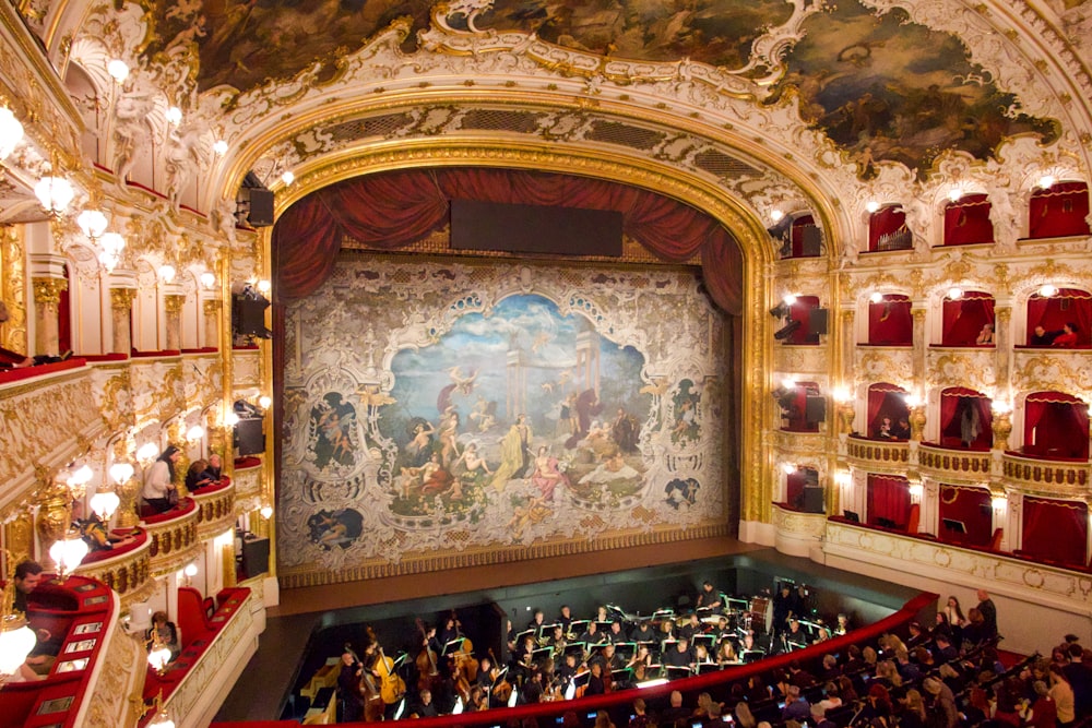 a group of people in a church with Teatro di San Carlo in the background