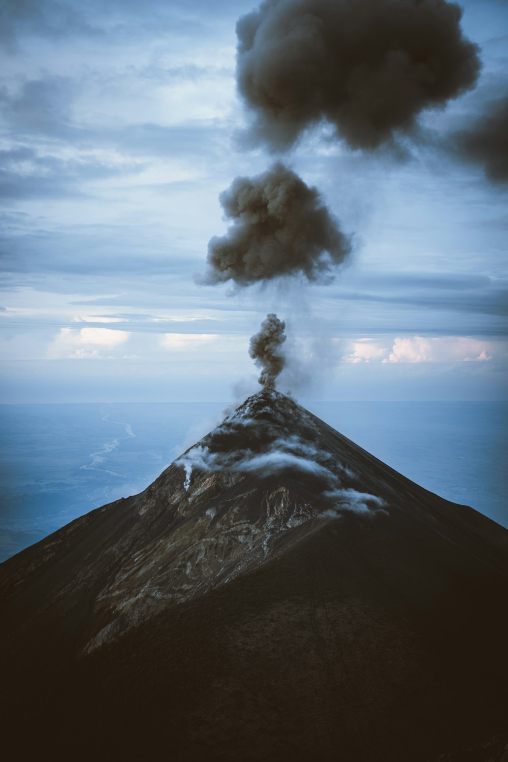 a volcano erupting with smoke