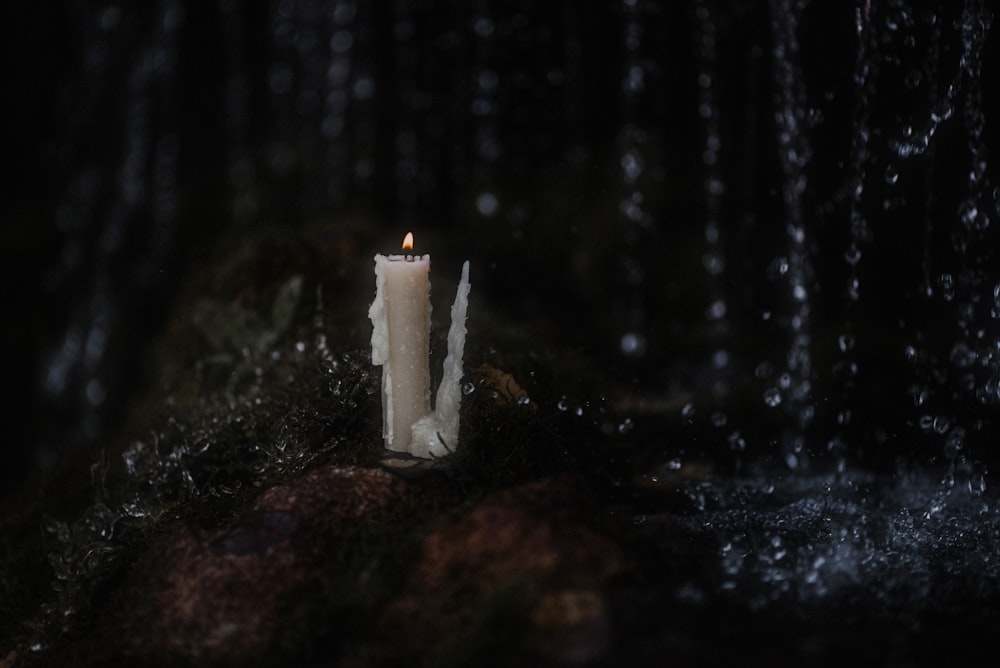 a candle on a rock