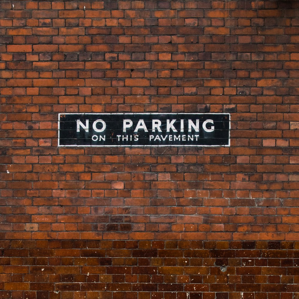 a sign on a brick wall