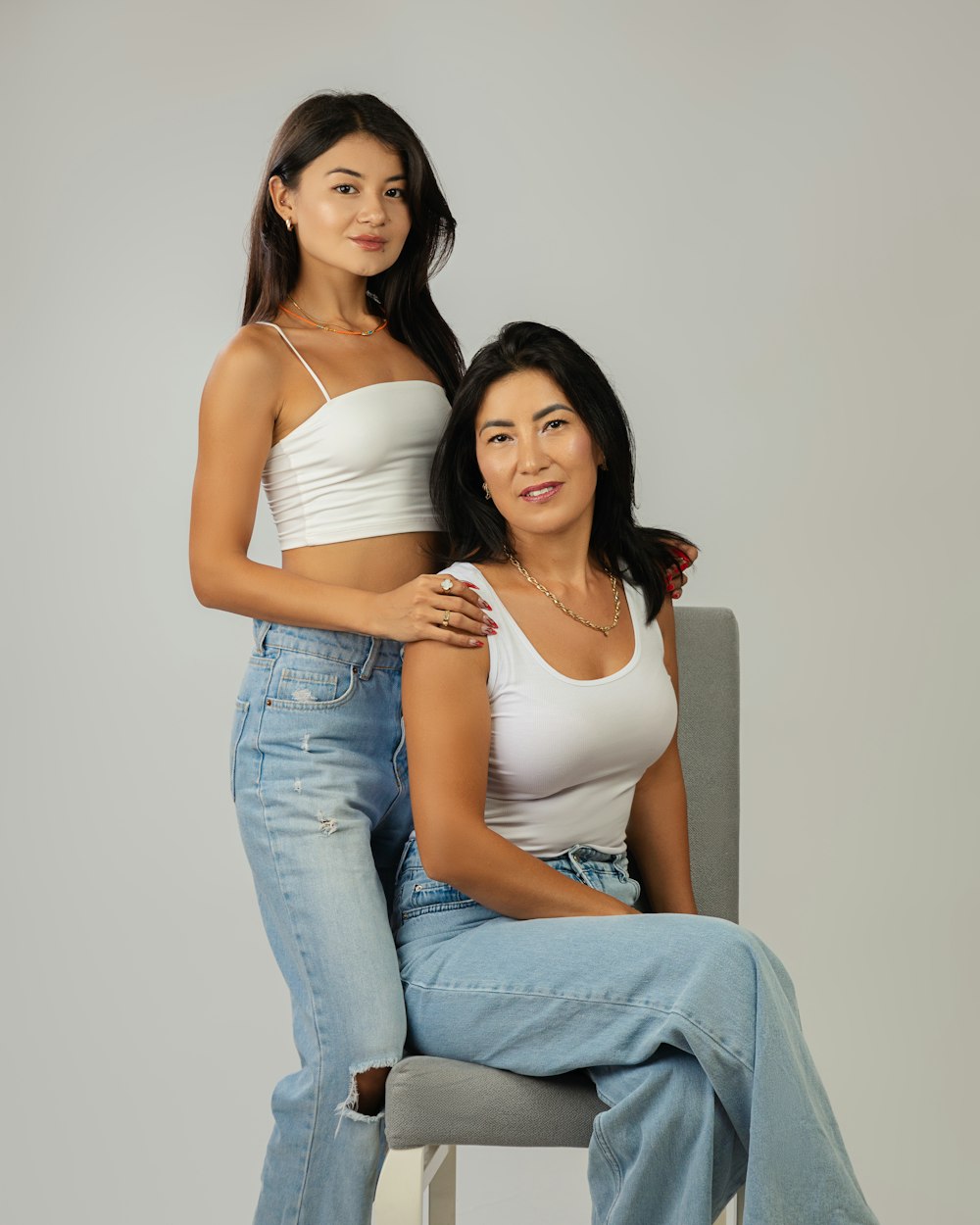 two women sitting on a chair