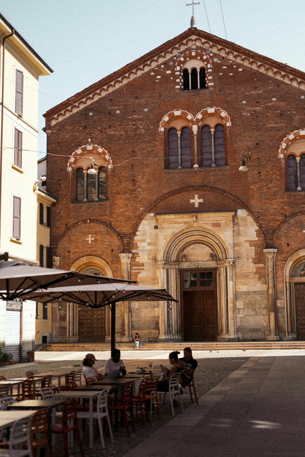 a brick building with tables and chairs outside