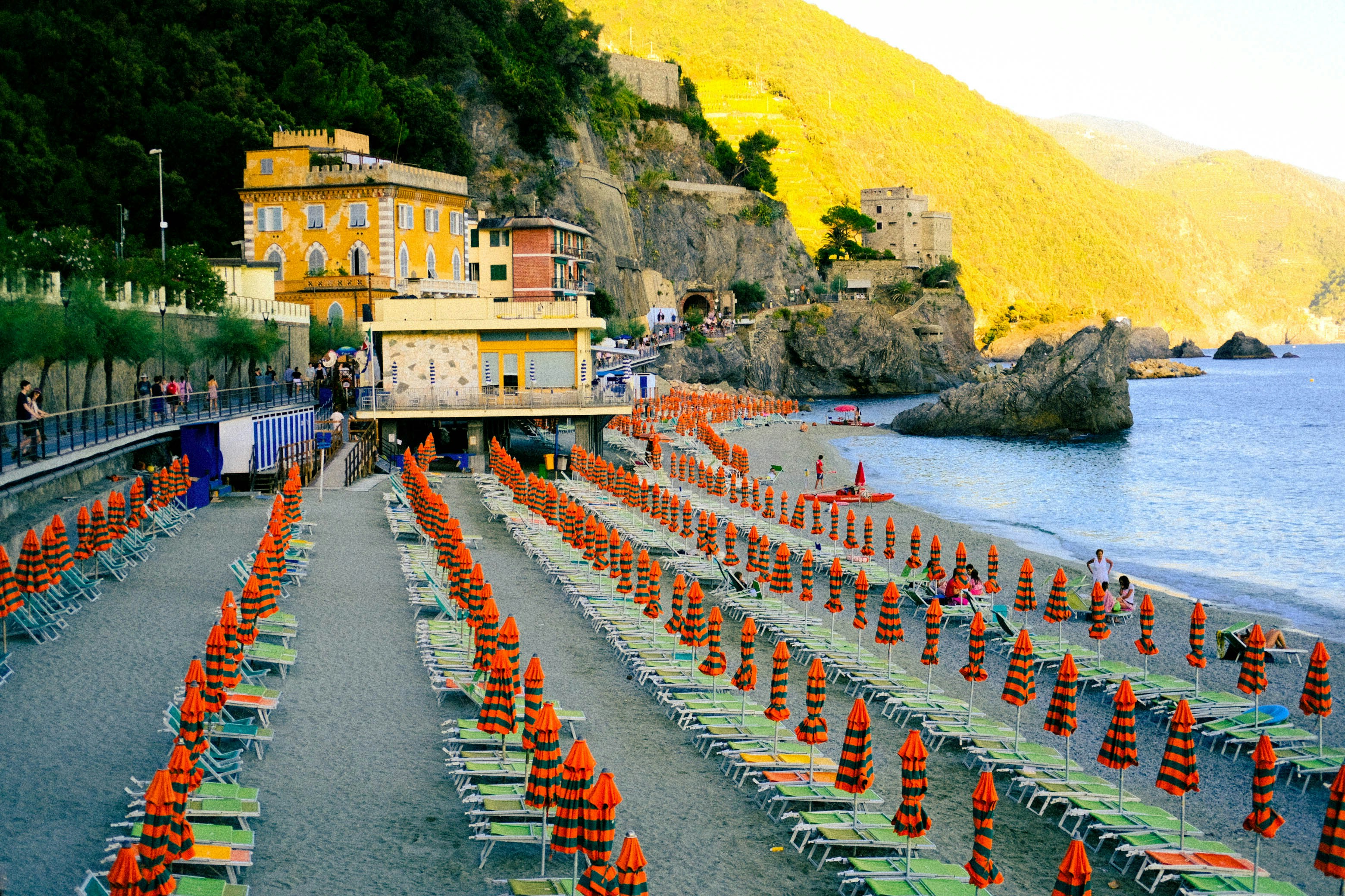 a building on the edge of a cliff next to a body of water