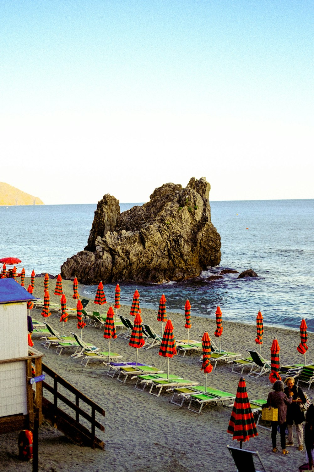 a beach with chairs and umbrellas