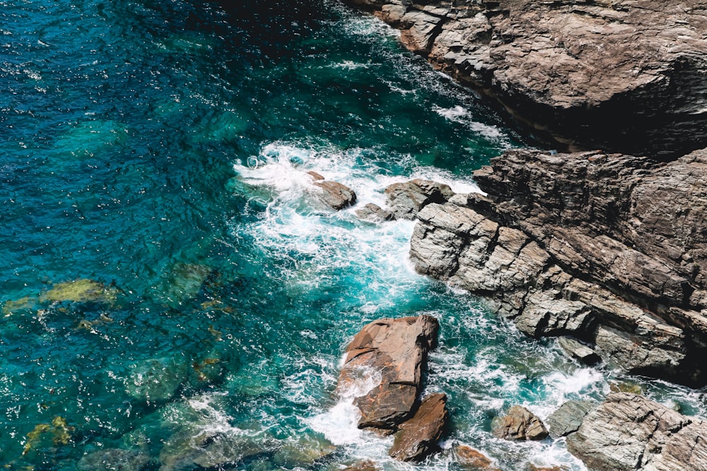 a body of water with rocks and a beach