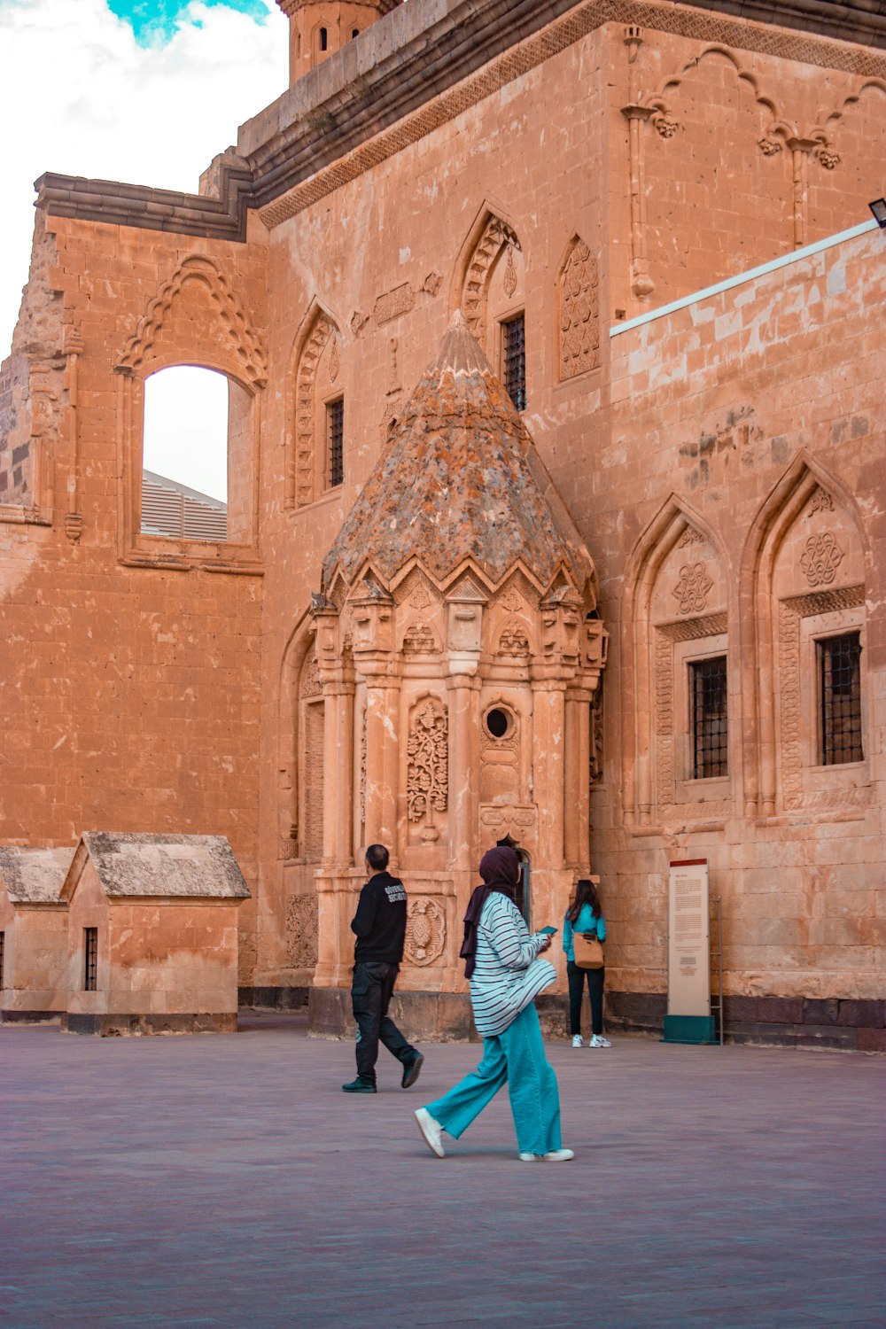 a group of people walking in front of a building