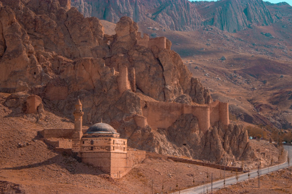 a building in the middle of a rocky canyon