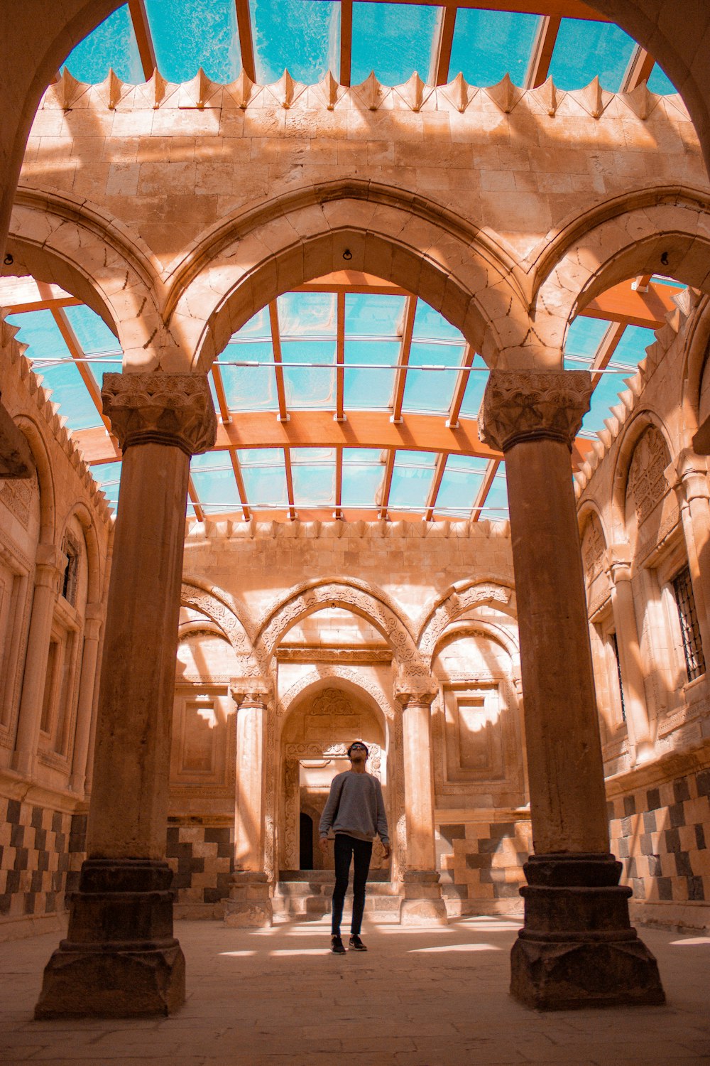 a person standing in a large room with many windows