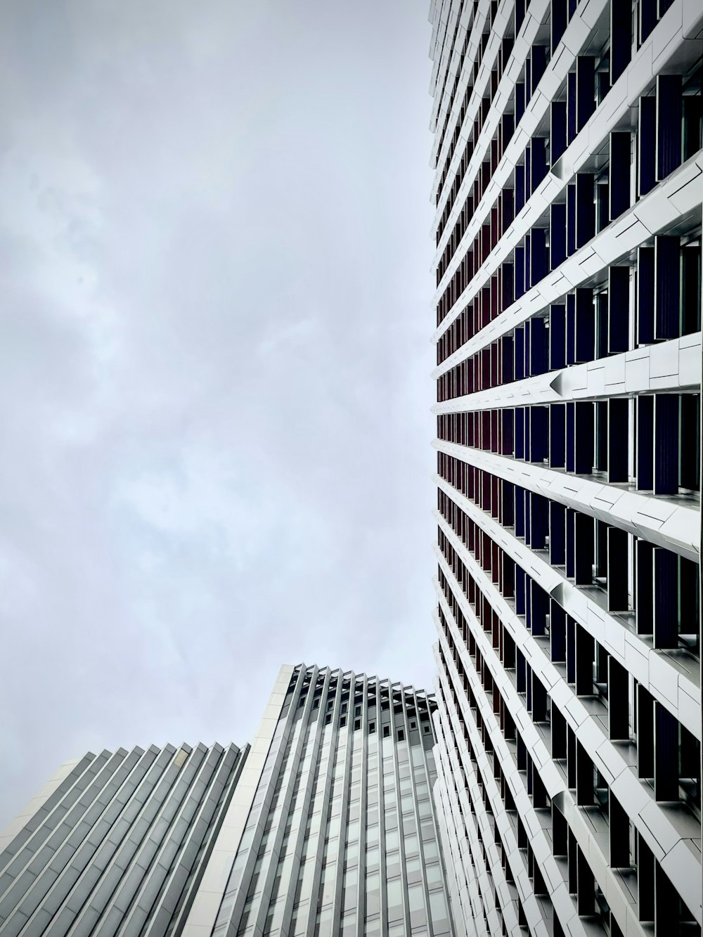 a few skyscrapers with clouds in the sky